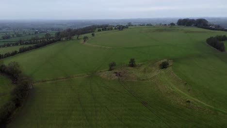 Drone-gliding,-unveils-misty-horizon-behind-the-Hill-of-Tara
