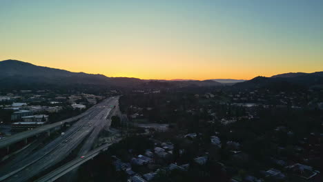 Aerial-drone-top-down-shot-over-downtown-Walnut-Creek,-with-traffic-movement-along-highway-680-during-evening-time
