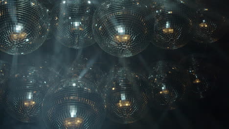 Mirror-balls-reflect-bright-light,-fog-creates-moving-light-beams