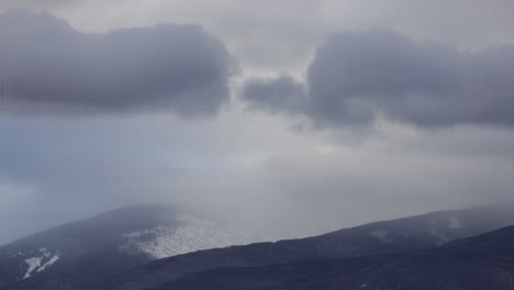 Timelapse-of-moving-clouds-in-mountains-with-snow