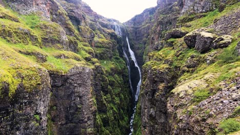 Glymur-waterfall-cascading-down-into-rugged-Icelandic-valley-canyon
