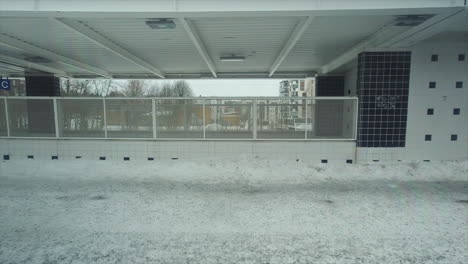 POV:-Winter-commuter-train-comes-to-stop-at-snowy-station-platform