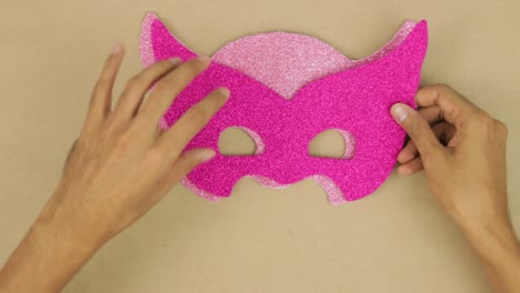 Measuring,-layering-and-join-pink-diamond-foam-with-hands,-carnival-mask