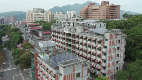 Taiwanese-urban-landscape-with-residential-buildings-and-solar-panels,-aerial-view