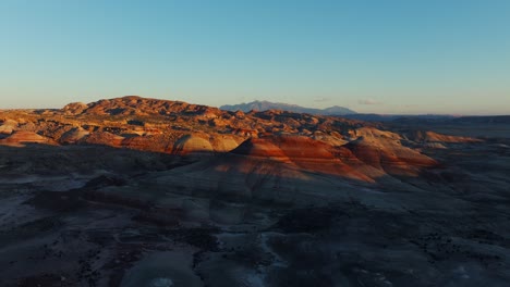 Birdseye-view-of-Bentonite-Hills-landscape-in-Utah-at-sunset,-USA