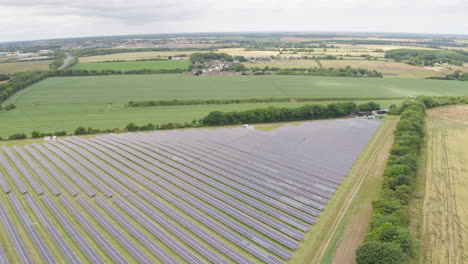 Triangular-field-of-solar-panels-aerial-drone-footage-with-surrounding-european-farmland