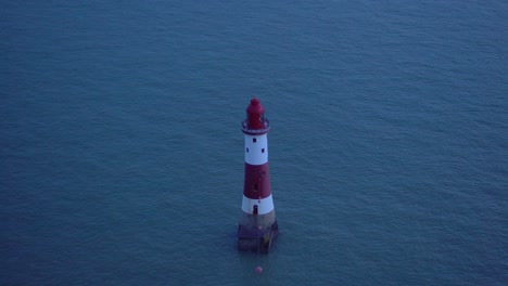 White-and-Red-Lighthouse-at-Sea:-Blinking-Light-at-Dusk