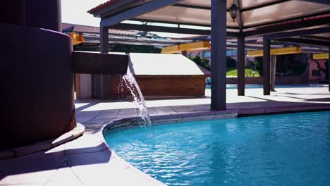 Luxury-poolside-fountain-in-sunlit-private-villa