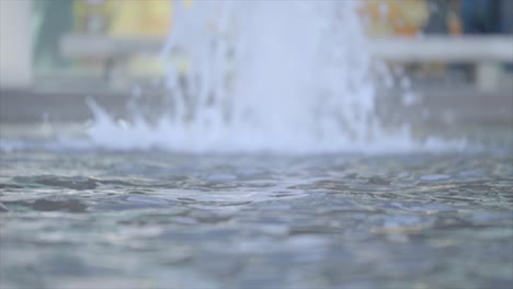 Slow-motion-surface-ripples-from-water-fountain-feature-SELECTIVE-FOCUS