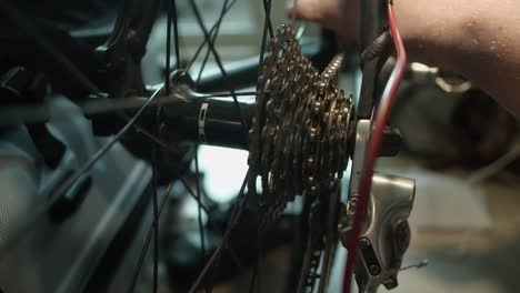 Closeup-view:-Bicycle-repair,-bike-chain-inspected-and-cleaned-in-shop