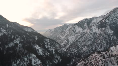 Wasatch-Mountains-at-Sunset-in-American-Fork-Canyon,-Utah---Aerial-in-Winter