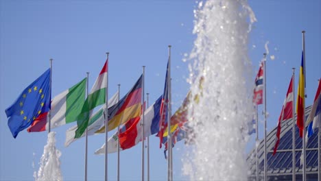 Wasserfontäne-Vor-Wehenden-Europäischen-Nationalflaggen-In-Zeitlupe
