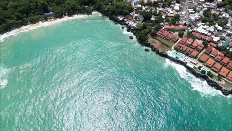 Stationary-drone-shot-over-a-costal-city-in-Dominican-Republic-next-to-the-beach