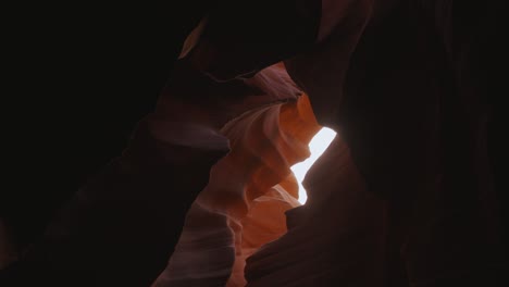 Antelope-Canyon-in-Arizona,-movement-at-beautiful-and-smooth-wavy-red-sandstone-walls