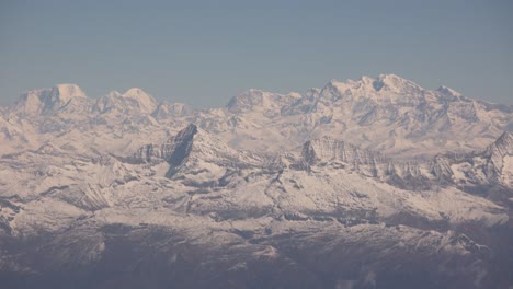Scenic-aerial-flight-over-the-worlds-largest-mountains,-the-Himalayas-with-views-of-Mount-Everest-and-jagged-snowcapped-peaks