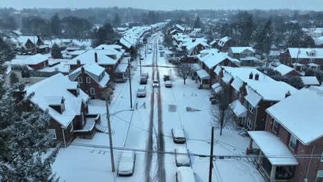 Snow-flurries-over-snowy-small-town-USA-street-during-winter