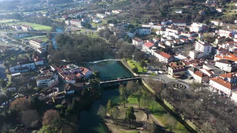 Bridge-over-River-Vez-or-Ponte-da-Vila-and-town-of-Arcos-de-Valdevez-in-Portugal,-aerial-establish