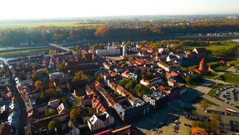 Drone-shot-of-Kaunas-old-town-with-Kaunas-castle,-churches-and-other-old-red-roof-houses-in-Kaunas,-Lithuania-on-a-sunny-day,-there-is-Confluence-of-Neman-and-Neris