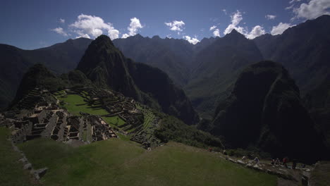 A-stunning-panoramic-view-of-Machu-Picchu,-Peru,-showcases-the-majestic-mountains-of-Putucusi-and-Huayna,-you-can-also-see-the-buildings-that-the-ancient-Inca-constructed-with-rectangular-structures