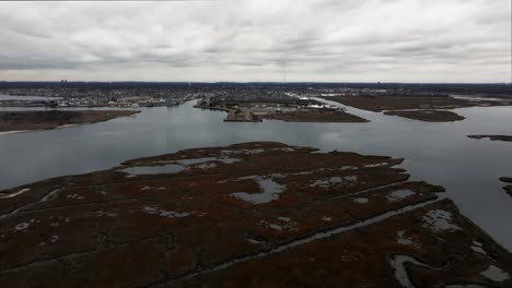 An-aerial-view-over-the-salt-marsh-off-Freeport,-New-York-on-a-cloudy-day