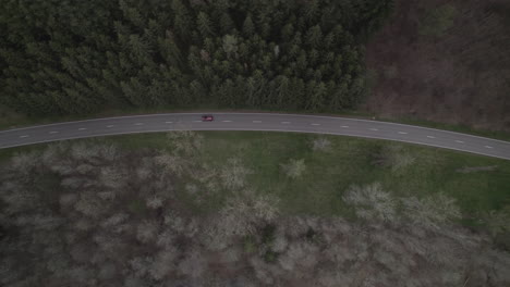 Drone-shot-in-Luxemburg-near-the-river-Lac-de-la-Haute-Sure-at-a-nature-park-Öewersauer-on-a-cloudy-day-with-cars-driving-on-the-road-near-the-forest-and-trees-LOG