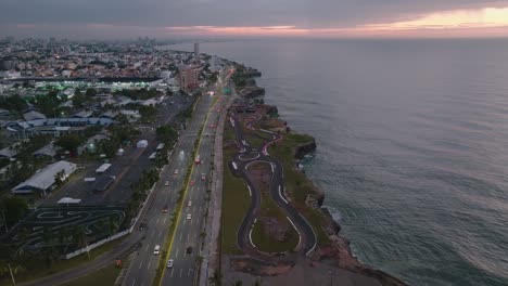 Highway-Santo-Domingo,-aerial-forward-nighttime-with-traffic-lights,-skyline