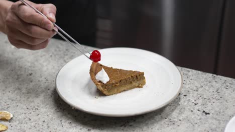 The-pastry-chef-and-his-apprentice-prepares-recipe-for-a-slice-of-pumpkin-brownie-cream-pie-dessert-with-cream-and-cherry