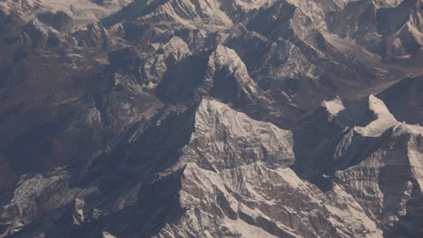 Scenic-aerial-flight-over-the-worlds-largest-mountains,-the-Himalayas-with-views-of-Mount-Everest-and-jagged-snowcapped-peaks