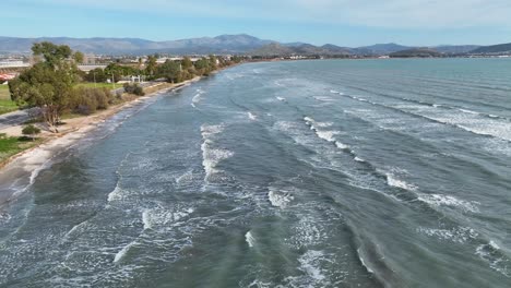 Aerial-footage-of-long-waves-on-the-beach-on-a-sunny-day