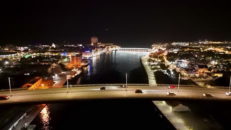 Aerial-pullback-over-Queen-Juliana-bridge-with-Handelskade-and-Punda-at-night