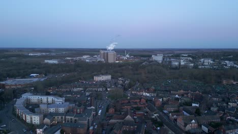 Bury-st-edmunds,-england-at-dusk-with-industrial-buildings-and-residential-areas,-aerial-view