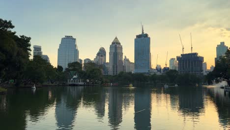 Bangkok-city-in-Thailand-view-tall-buildings-and-Lumpini-park-lake-reflexion