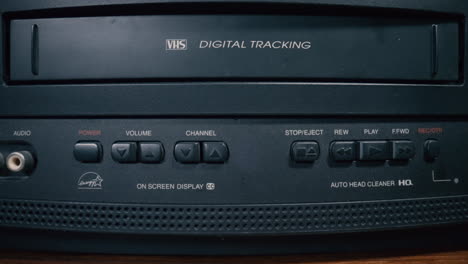 Inserting-VHS-Cassette-into-a-Vintage-VCR