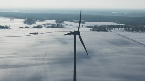 Close-up-in-slow-motion-of-a-wind-turbine-against-the-snowy-backdrop-of-the-Baltic-countryside