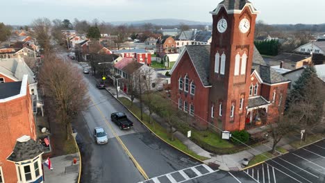 American-church-tower-in-small-american-city-with-driving-cars-at-sunset