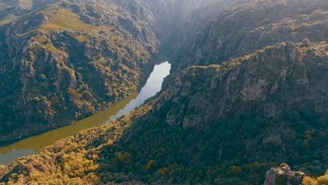 A-drone-video-captures-stunning-views-of-mountainous-landscapes-with-a-river-flowing-through-the-heart-of-nature