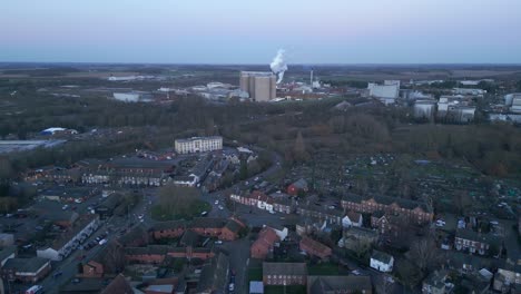 Bury-st-edmunds-in-england-during-twilight,-showcasing-residential-areas-and-industrial-buildings-in-the-distance,-aerial-view