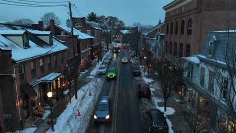 Rising-drone-shot-of-traffic-in-american-town-at-dusk-in-winter