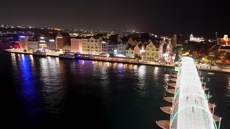 Panoramic-aerial-dolly-above-holiday-lights-reflecting-on-water-of-Handelskade-Curacao