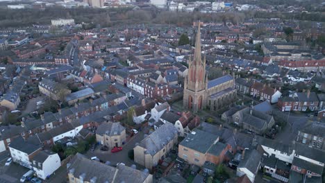 Bury-st-edmunds-town-with-historic-church-prominent,-early-evening-light,-aerial-view