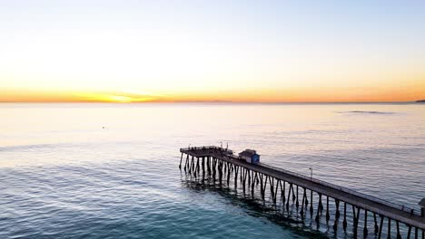Aerial-View-of-southern-california-pier-with-a-beautful-orange-sunset
