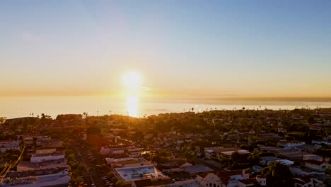 Aerial-Hyperlapse-of-beautiful-sunset-over-california-beach-town-towards-pacific-ocean