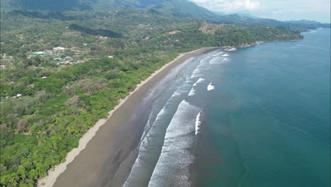 Flying-into-Costa-Rica-coast-with-a-drone-with-mountains-in-the-background