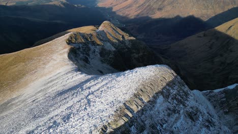 Snowy-mountain-ridge-aerial-Stob-Ban-Highlands-Scotland-in-winter