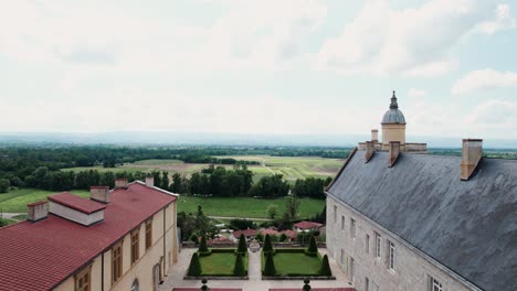 backward-drone-shot-revealing-the-chateau-de-Boutheon-in-Andrezieux-Boutheon,-Loire-Forez,-Loire-departement,-France