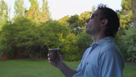 Man-drinking-mate-and-relaxing-in-garden-of-his-house-with-traditional-Argentina-drink