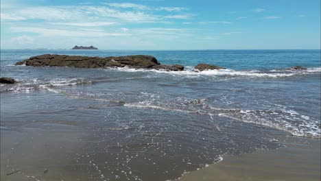 Fying-from-Costa-Rica-beach-into-ocean-through-crashing-waves