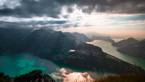 Sunlight-shines-between-breaks-in-clouds-on-top-lake-Vierwaldstattersee-of-Fronalpstock-mountains-Switzerland