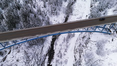 Traffic-Flows-Beneath-Paulson's-Snowy-Archway-in-Winter-,-Birdseye-views