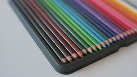 Closeup-of-color-pencils-arranged-in-a-rainbow-pattern-slowly-rotating-from-angle